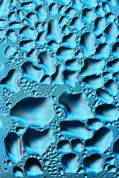 Colorful abstract background. Beautiful macro shot of water drops on a window.