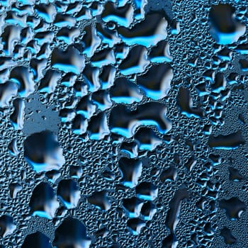 Colorful abstract background. Beautiful macro shot of water drops on a window.