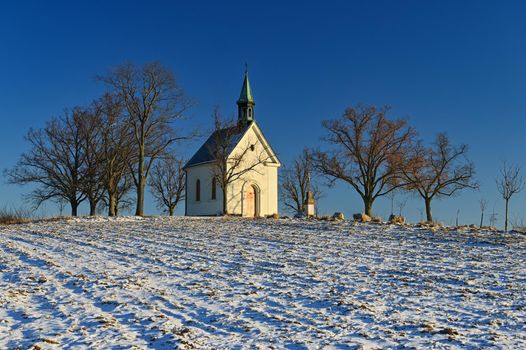 Beautiful winter landscape with church. Sunny winter day. Brno - Líšeň. Chapel of Our Lady of Helper.