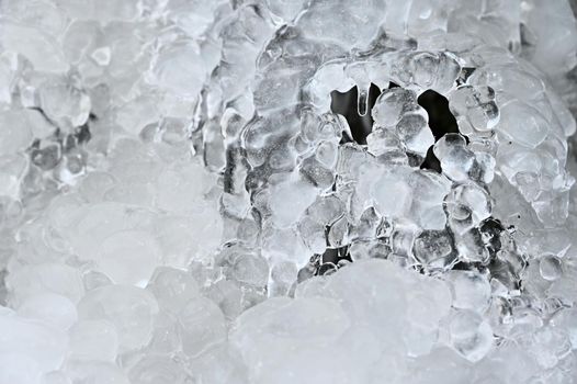 Frozen stream. Beautiful winter nature background. Frost, ice and snow in the winter.