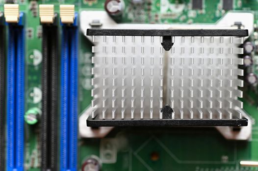 Computer motherboard with heat sink. Printed Circuit Board. Background concept for electrical engineering and modern technology.