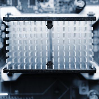 Computer motherboard with heat sink. Printed Circuit Board. Background concept for electrical engineering and modern technology.