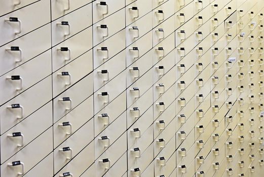 Background with wooden white drawers.