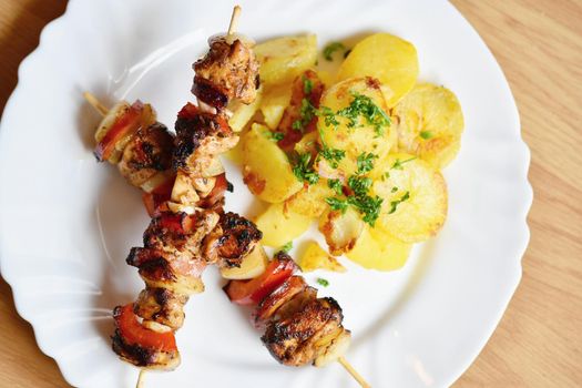 Chicken skewer with potatoes and parsley. Excellent meat with vegetables.