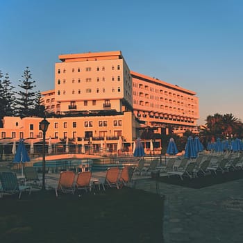Beautiful hotel - beach resort at sunset. Summer background for travel and holidays. Greece Crete.