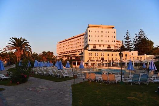 Beautiful hotel - beach resort at sunset. Summer background for travel and holidays. Greece Crete.