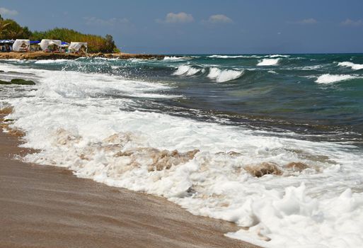Beautiful clean sea and waves. Summer background for travel and holidays. Greece Crete.. Amazing scenery on the beach. 