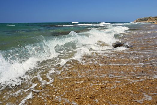 Beautiful clean sea and waves. Summer background for travel and holidays. Greece Crete.. Amazing scenery on the beach. 