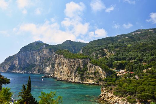 Beautiful beach and boats. Clean sea with a bay. Concept for travel, vacation and tourism. Great place for summer holidays and swimming. Paleokastritsa, Corfu island, Greece.