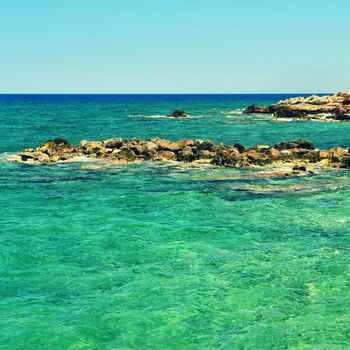 Beautiful clean sea and waves. Summer background for travel and holidays. Greece Crete.. Amazing scenery on the beach. 