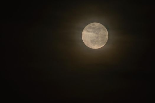 Full moon over dark black sky at night