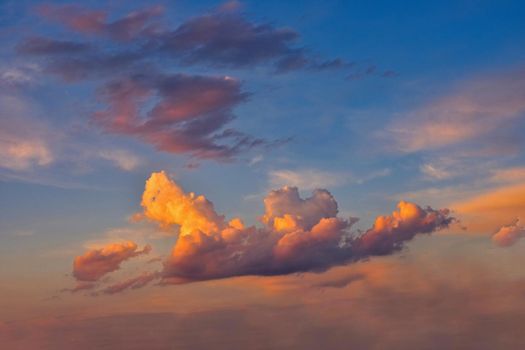 Beautiful colorful clouds on blue sky at sunset. Romantic background concept.
