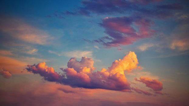 Beautiful colorful clouds on blue sky at sunset. Romantic background concept.
