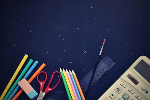 Background back to school. Blackboard with school aids.