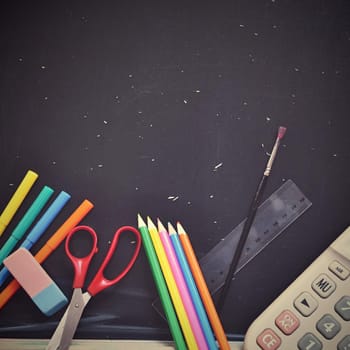 Background back to school. Blackboard with school aids.