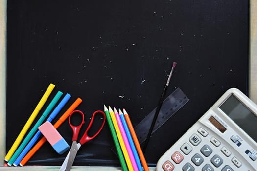Background back to school. Blackboard with school aids.