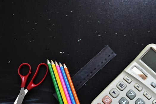 Background back to school. Blackboard with school aids.