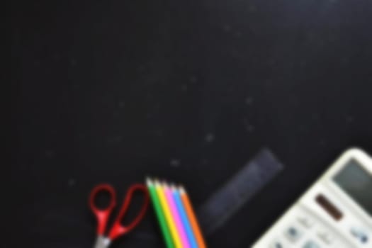 Background back to school. Blackboard with school aids.