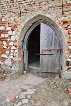 Old open the church door with a brick wall.