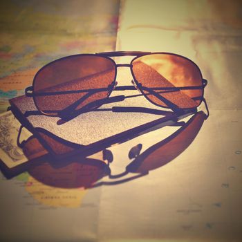 Beautiful concept for summer travel. Sunglasses with passport. Planning a summer vacation and holidays.