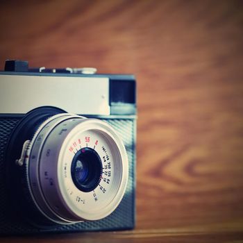 Russian old analog camera on a wooden background.