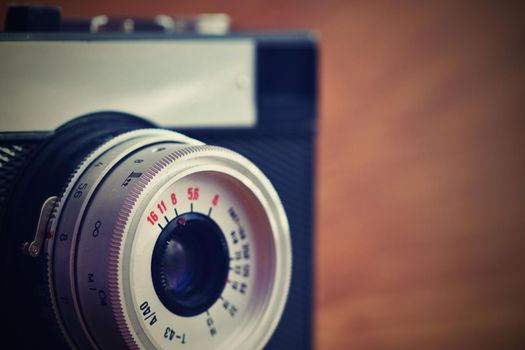 Russian old analog camera on a wooden background.