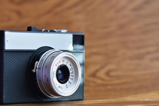 Russian old analog camera on a wooden background.