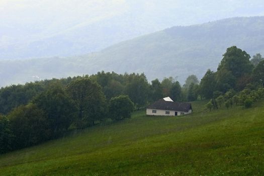 cottage in the rain. Mountains in the summer on a rainy day. White Carpathians Czech Republic.. Landscape - nature.

