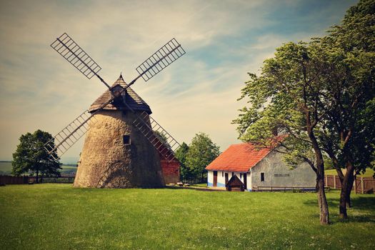 Old windmill - Czech Republic Europe. Beautiful old traditional mill house with a garden. Kuzelov - South Moravia.