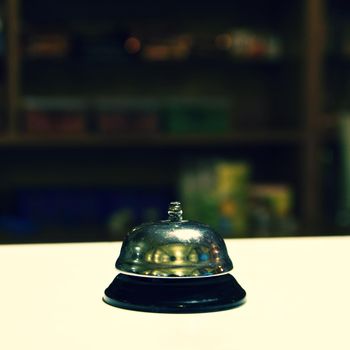 Receptionist bell. Blurred background reception or restaurant.