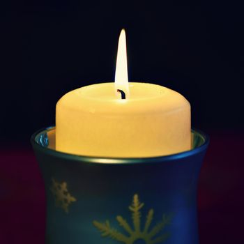 beautiful candle burning with a pure black background