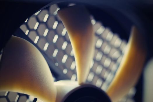Computer power supply fan. Nice detail quality quiet cooler with beautiful light and texture of the chassis.