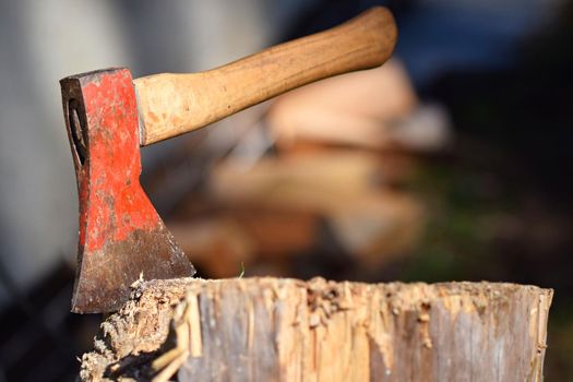Ax in the stump. nice color natural blurred background