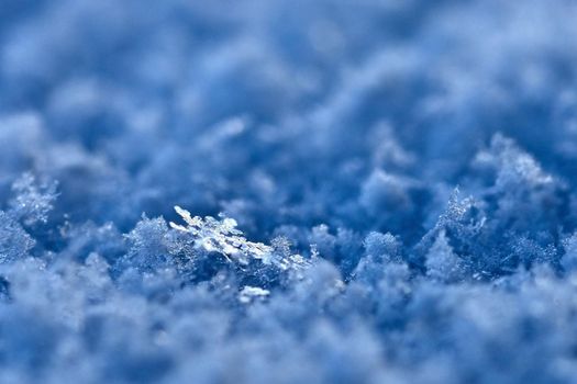 Snowflake. Macro photo of real snow crystal. Beautiful winter background seasonal nature and the weather in winter.