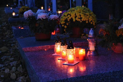 Beautiful autumn concept. Cemetery and Halloween. Candle in a lantern on the grave. Background for Halloween.