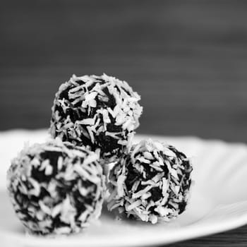 Christmas sweets on a plate - Rum balls in coconut. Traditional homemade handmade Czech sweets.