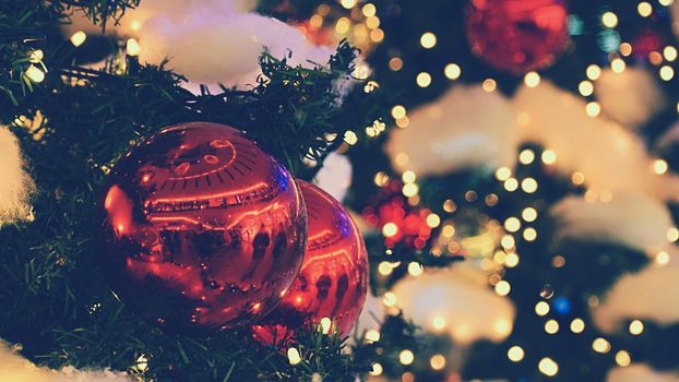 Colorful christmas Decoration. Winter holidays and traditional ornaments on a Christmas tree. Lighting chains - candles for seasonal background.