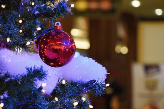 Colorful christmas Decoration. Winter holidays and traditional ornaments on a Christmas tree. Lighting chains - candles for seasonal background.