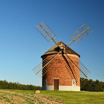 Beautiful old windmill and landscape with the sun. Chvalkovice - Czech Republic. Europe.