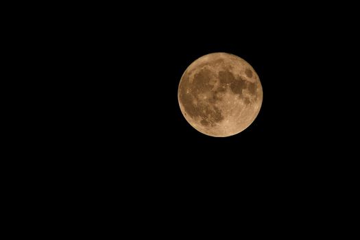 Full moon over dark black sky at night
