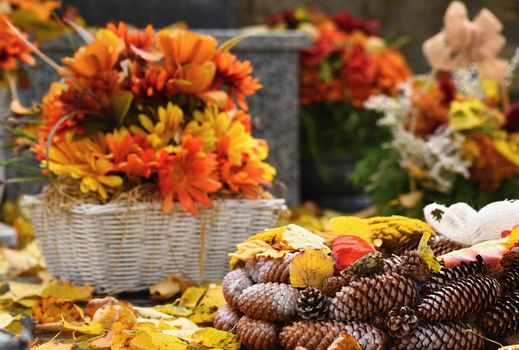 Autumn nature concept. Beautiful autumn decorations. Colorful autumn flowers at the cemetery - Halloween.