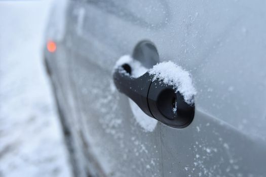 Winter car, the concept of winter car ride.Icing on the handle of the car.