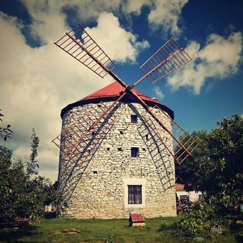 Beautiful old windmill and landscape with the sun. Ostrov u Macochy, Czech Republic. Europe.