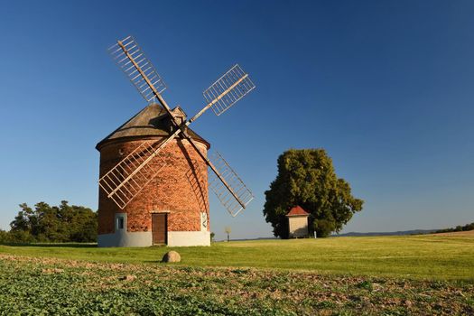 Beautiful old windmill and landscape with the sun. Chvalkovice - Czech Republic. Europe.