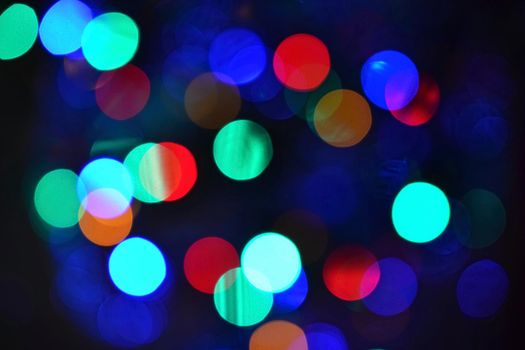 Color Abstract Blurred backgrounds - bokeh. Christmas lights on a pure black background. Preparing for the Holidays.