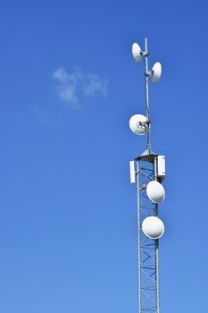 Telecommunication tower mast TV antennas wireless technology with blue sky