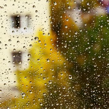 Rain. Autumn seasonal background with rain drops on the window.