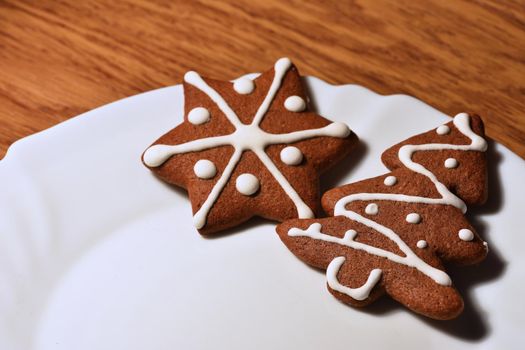 Christmas tree and snowflake. Beautiful sweet Christmas candy. Hand-decorated, homemade gingerbread.