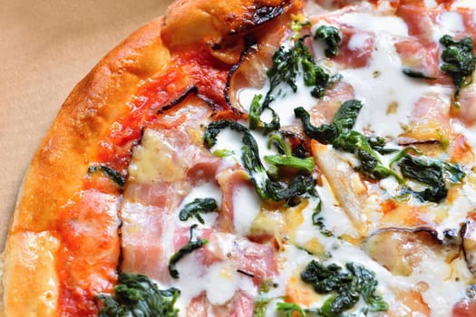 Excellent fresh pizza with cheese, bacon, cream and spinach. Tasty Fast Italian Food.