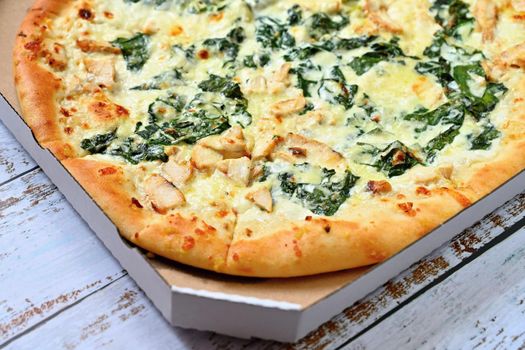 Close-up photos of food. Delicious fresh pizza with cream and spinach.